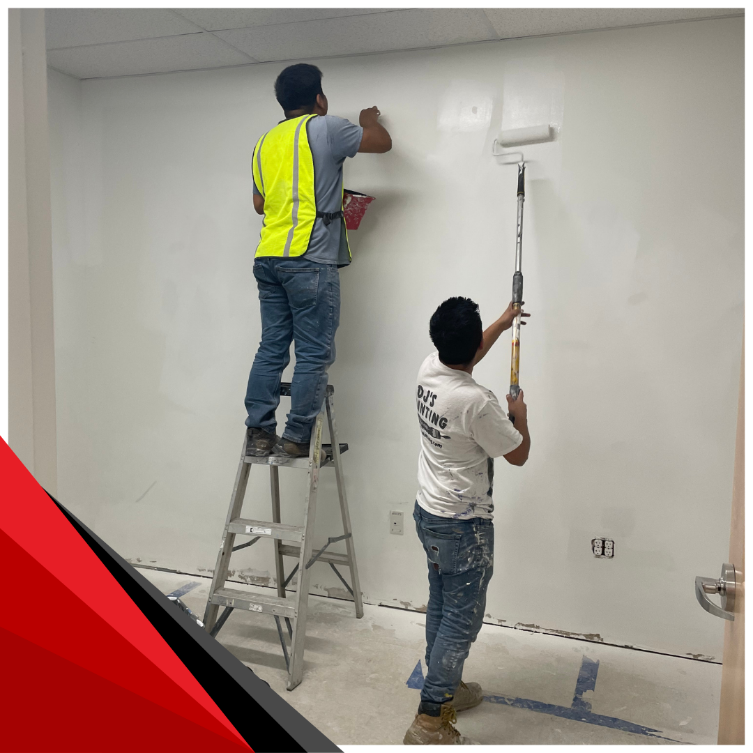 2 expert painters working together to paint a interior office wall 