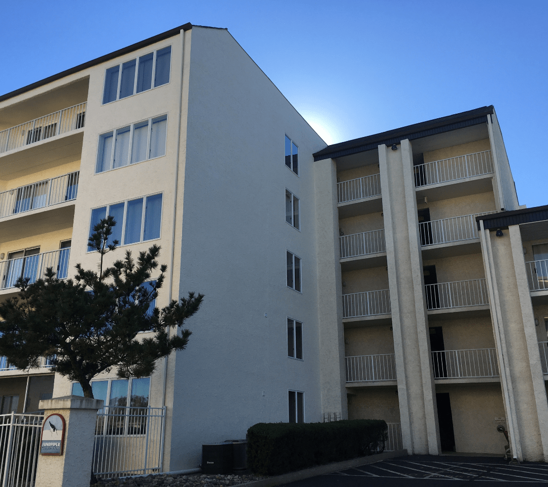 Painting of 5 Story Stucco building with brown trim